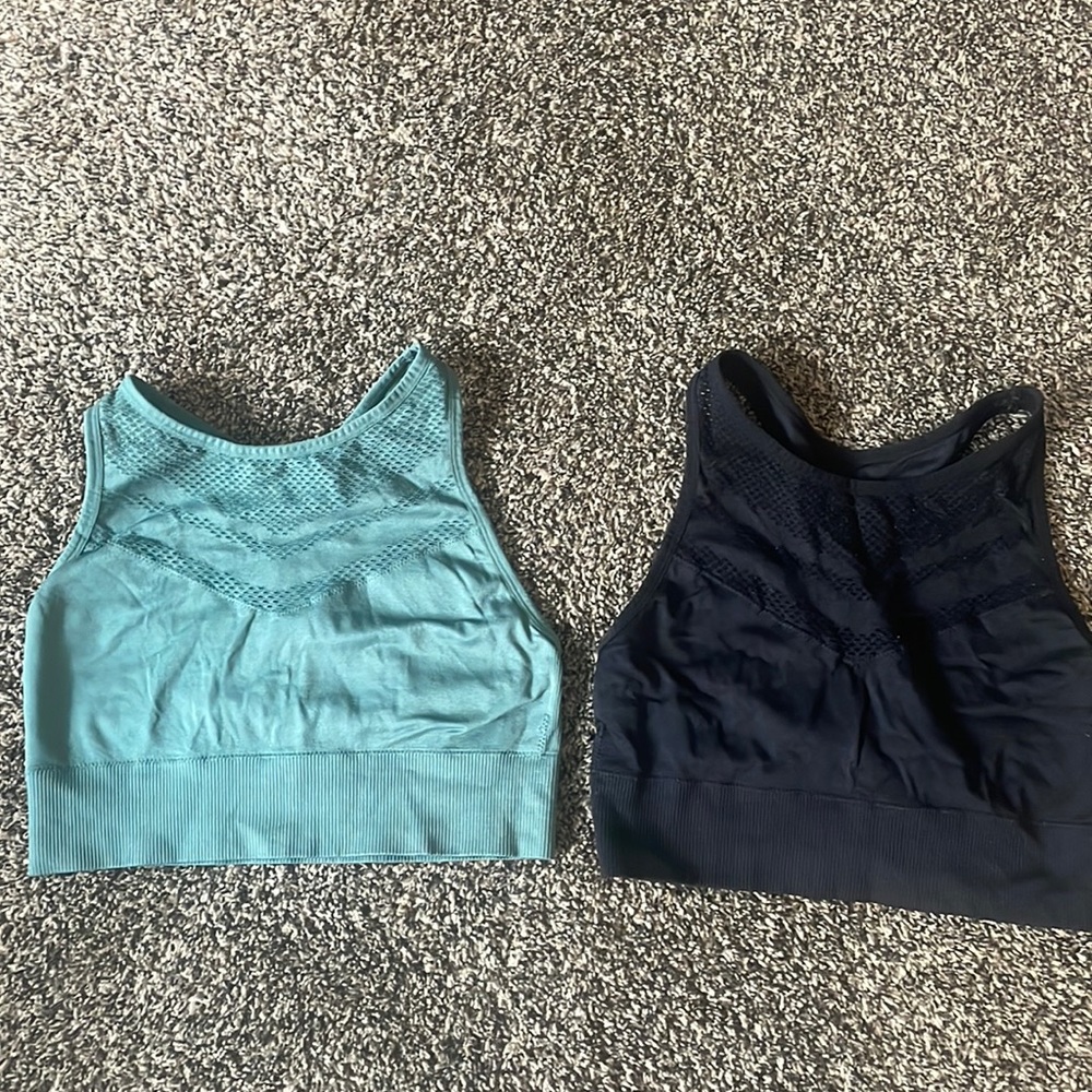 Set of two high neck sports bras. One green one black